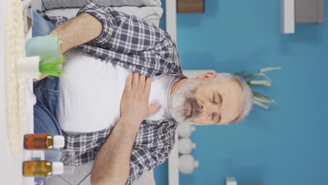 Vertical-video-of-The-sick-old-man-can't-stop-coughing.